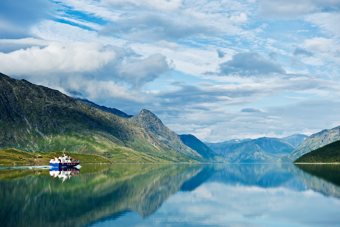 Passenger ferry boat travel from Gjendesheim towards Memurubu on Lake Gjende, Jotunheimen national park, Norway