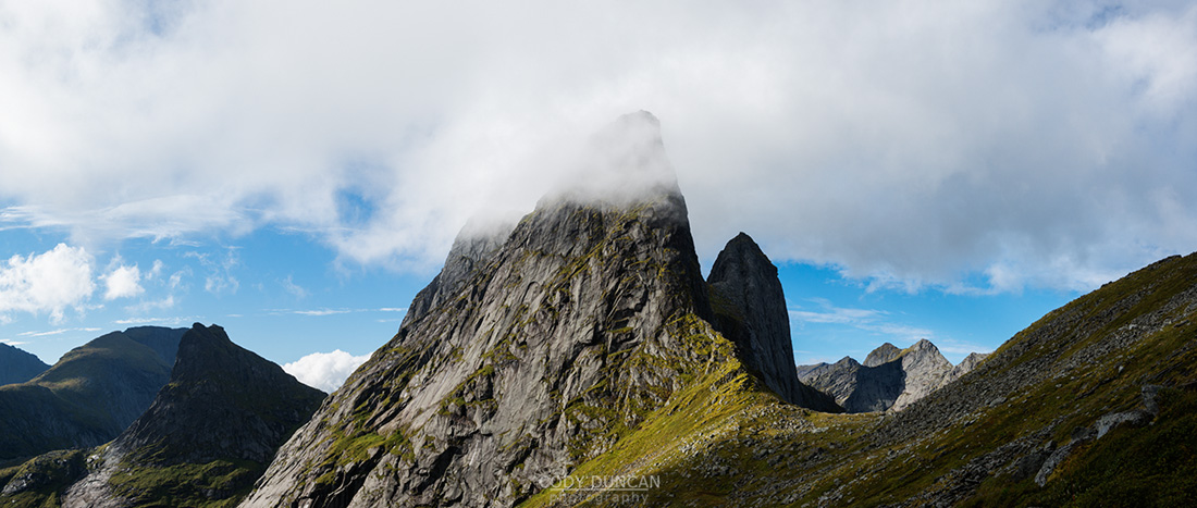 Clouds conceal dramatic mountain peak of Kråkhammartind, Moskenesoy, Lofoten Islands, Norway