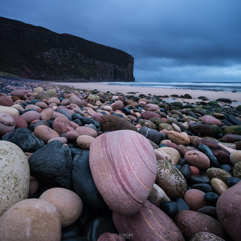 Red sandstone boulders on beach at Rackwick Bay, Hoy, Orkney, Scotland