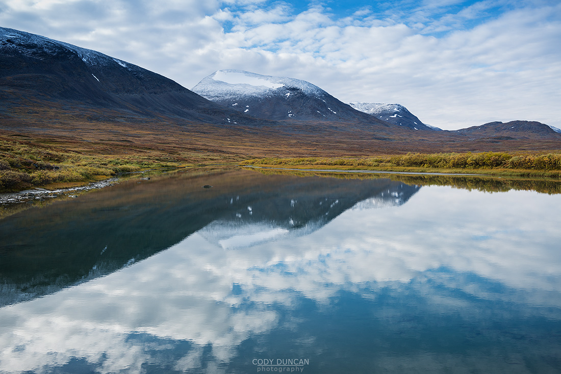 Autumn mountain reflection in river, Alisvagge from near Alesjaure mountain hut, Kungsleden trail, Lappland, Sweden