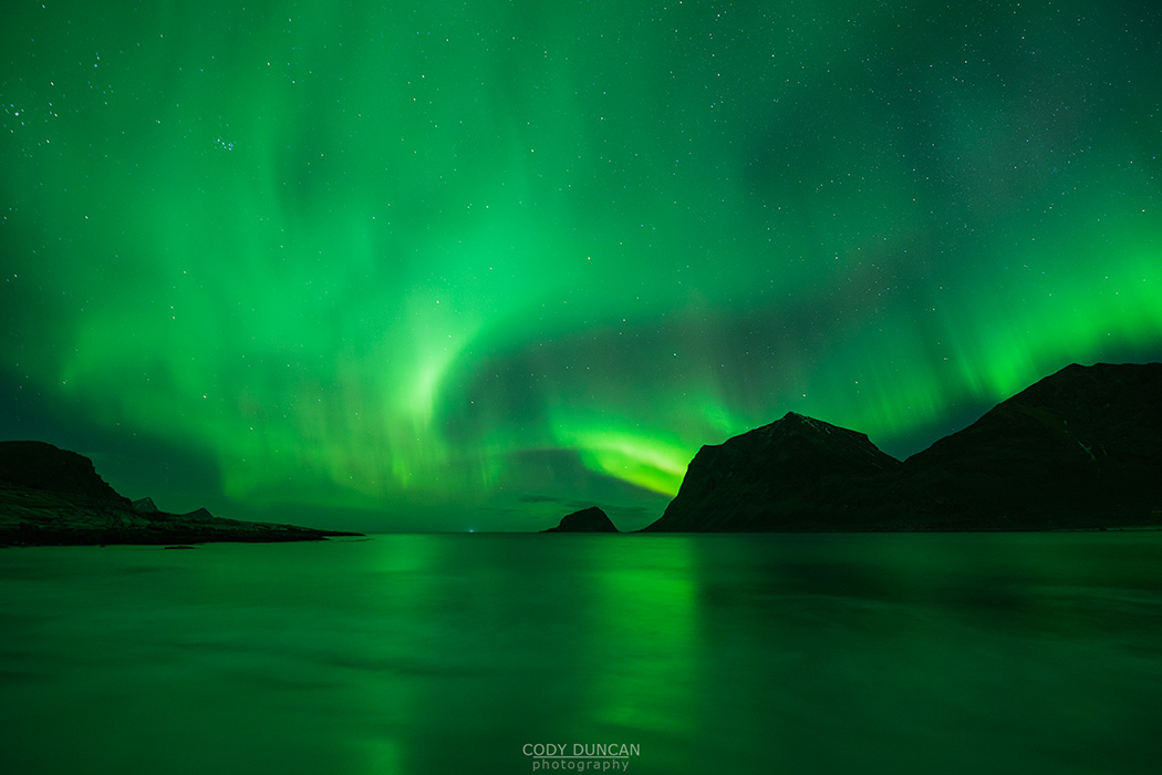 Northern Lights - Aurora Borealis shine in Sky over Vik Beach, Vestvågøy, Lofoten Islands, Norway