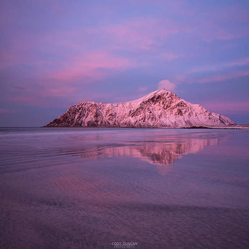 Hustind mountain peak glows pink over Skagsanden beach, Flakstad, Flakstadøy, Lofoten Islands, Norway