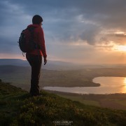 Female hiker takes in view of Llangorse lake from Mynydd Llangorse, Brecon Beacons national park, Wales